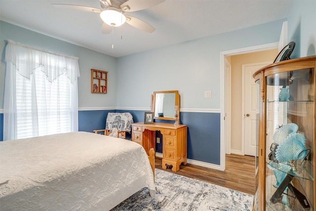 bedroom with hardwood / wood-style floors and ceiling fan