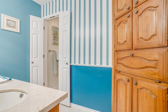 bathroom featuring tile patterned flooring and vanity