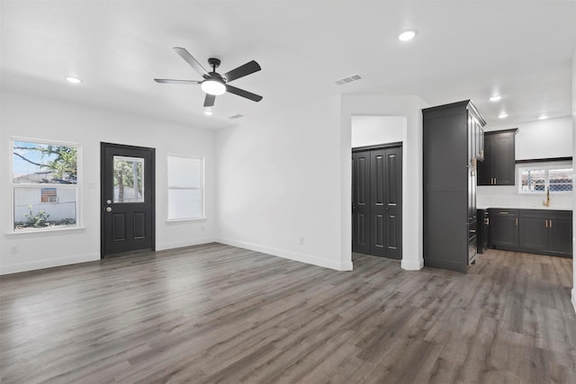 interior space featuring ceiling fan and dark wood-type flooring