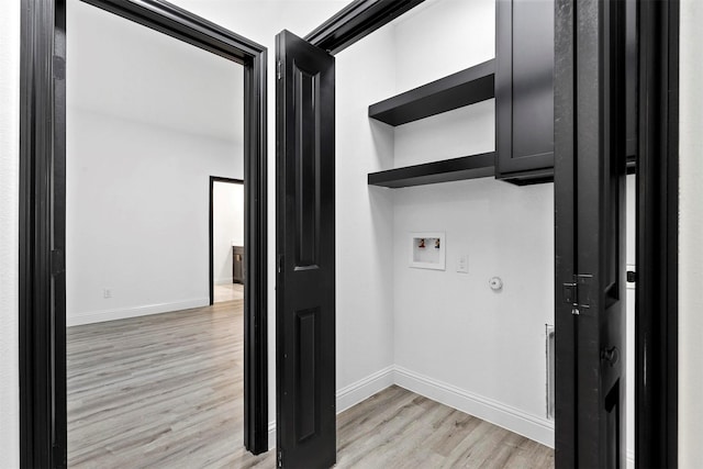 laundry area featuring washer hookup and light hardwood / wood-style flooring