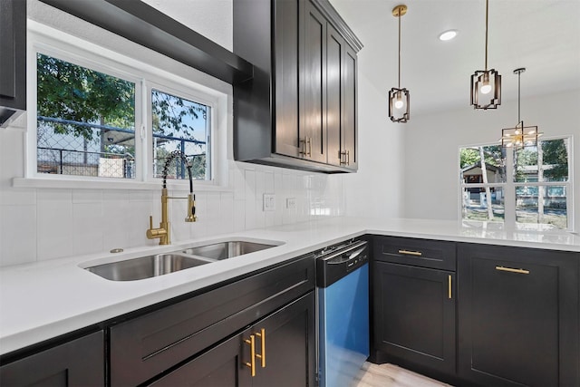 kitchen featuring pendant lighting, stainless steel dishwasher, plenty of natural light, and sink