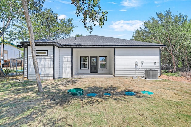 back of house with a lawn, a patio, and central AC