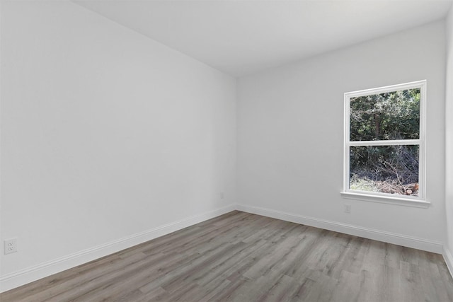 spare room with light hardwood / wood-style flooring