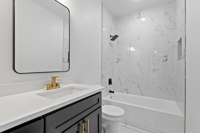 full bathroom with tiled shower / bath combo, toilet, and vanity