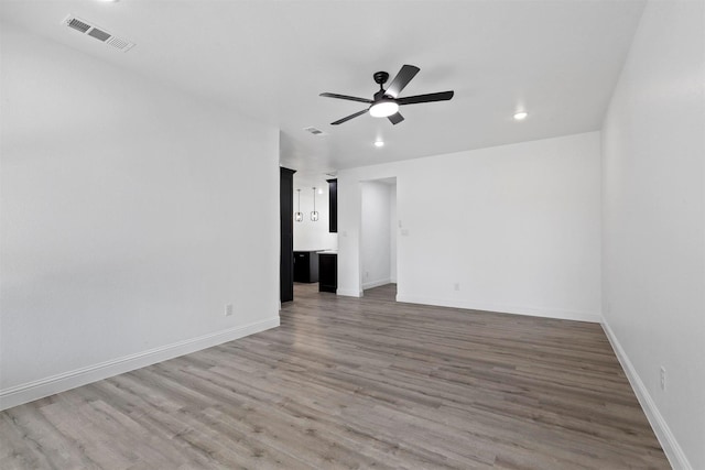 unfurnished room with wood-type flooring and ceiling fan