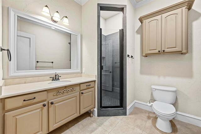 bathroom with tile patterned floors, toilet, vanity, a shower with shower door, and ornamental molding