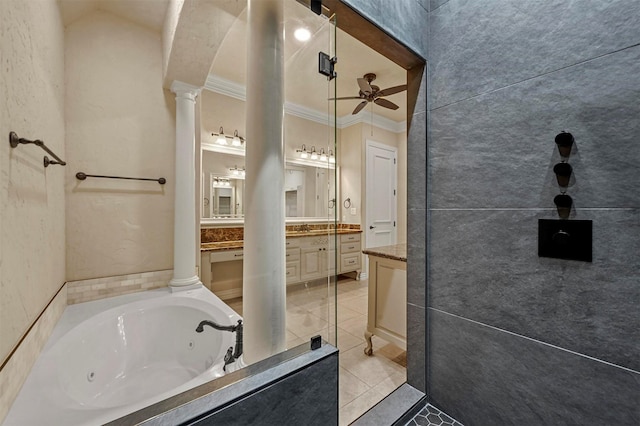 bathroom featuring tile patterned floors, ornate columns, vanity, crown molding, and a bathing tub