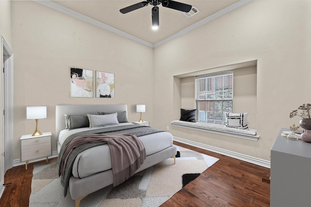 bedroom with wood-type flooring, ceiling fan, and crown molding