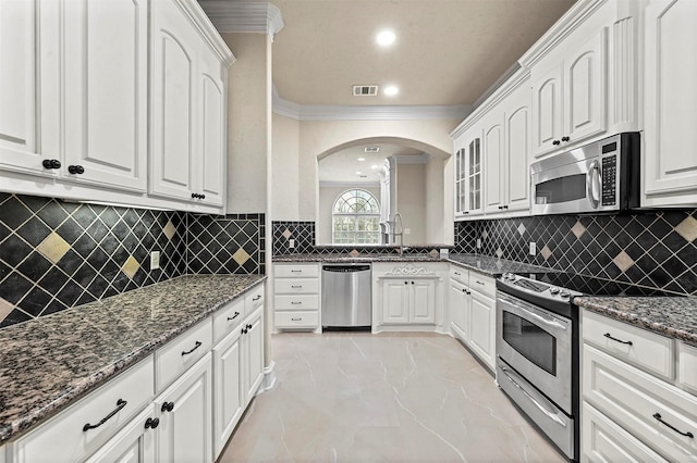 kitchen with white cabinets and appliances with stainless steel finishes