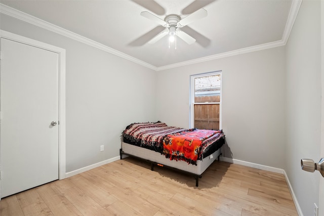 bedroom featuring ceiling fan, ornamental molding, and light hardwood / wood-style flooring