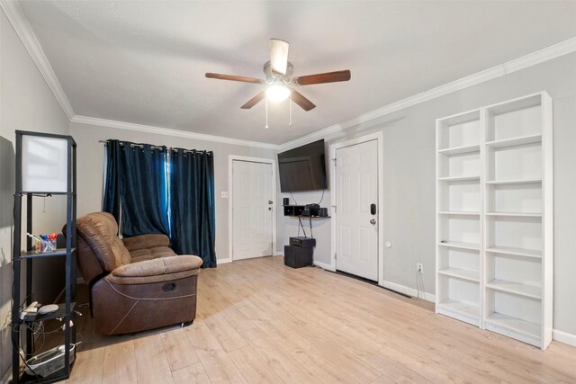 sitting room with ceiling fan, ornamental molding, and light wood-type flooring