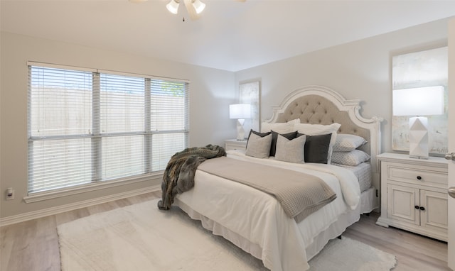 bedroom with light hardwood / wood-style flooring, multiple windows, and ceiling fan