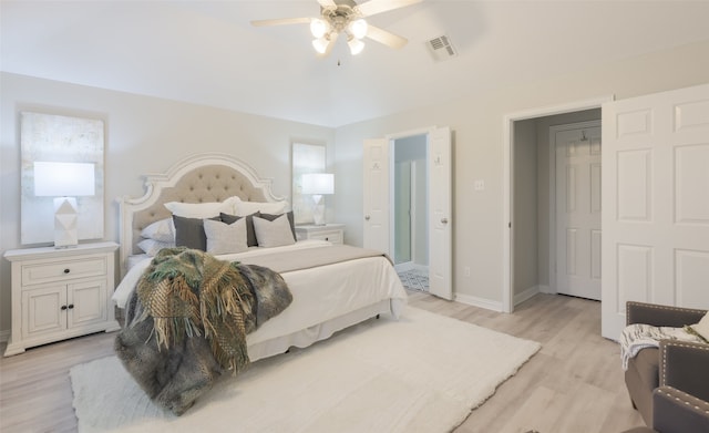 bedroom with light hardwood / wood-style floors and ceiling fan