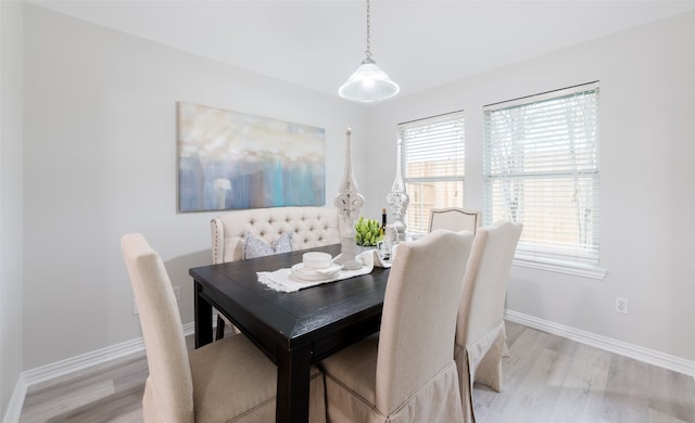 dining space with light hardwood / wood-style flooring and plenty of natural light