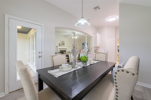 dining space featuring ceiling fan, light hardwood / wood-style floors, and lofted ceiling