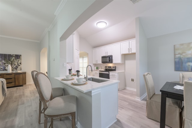 kitchen with tasteful backsplash, kitchen peninsula, stainless steel range with electric stovetop, white cabinets, and light wood-type flooring