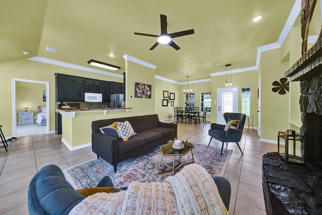 tiled living room with ceiling fan, lofted ceiling, and ornamental molding