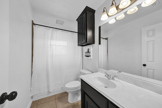 full bathroom with tile patterned floors, shower / bath combo with shower curtain, vanity, and toilet