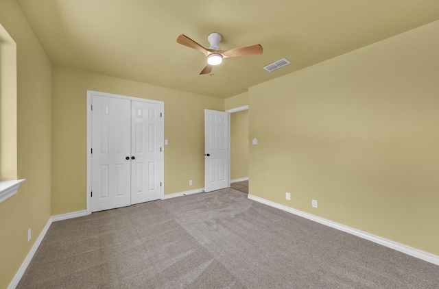 unfurnished bedroom featuring light carpet, a closet, and ceiling fan