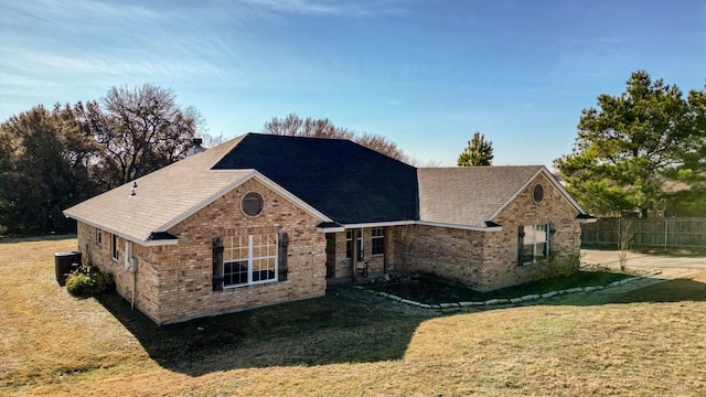 view of front of property featuring central AC unit and a front lawn