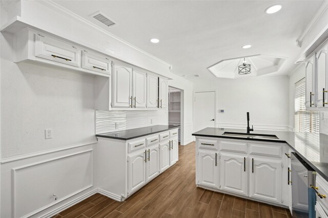 kitchen with ornamental molding, white cabinetry, sink, and dark wood-type flooring