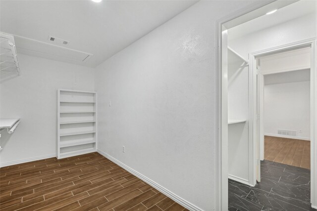 spacious closet featuring dark hardwood / wood-style floors