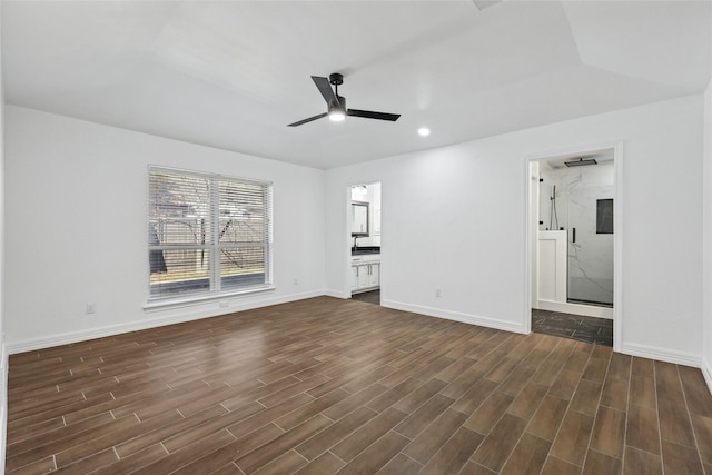 unfurnished living room with ceiling fan and dark wood-type flooring