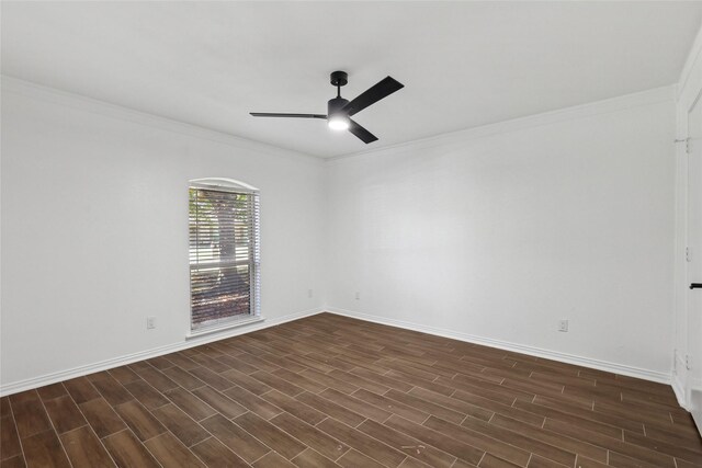 spare room featuring dark hardwood / wood-style floors and crown molding