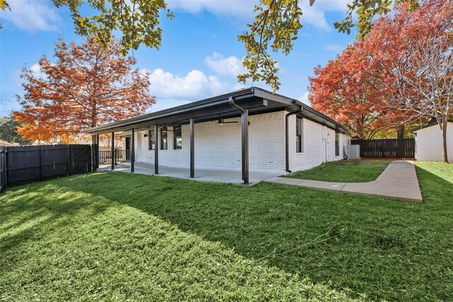 view of home's exterior with a lawn and a patio area