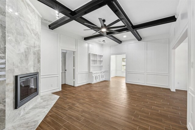 unfurnished living room with beam ceiling, dark hardwood / wood-style flooring, and coffered ceiling