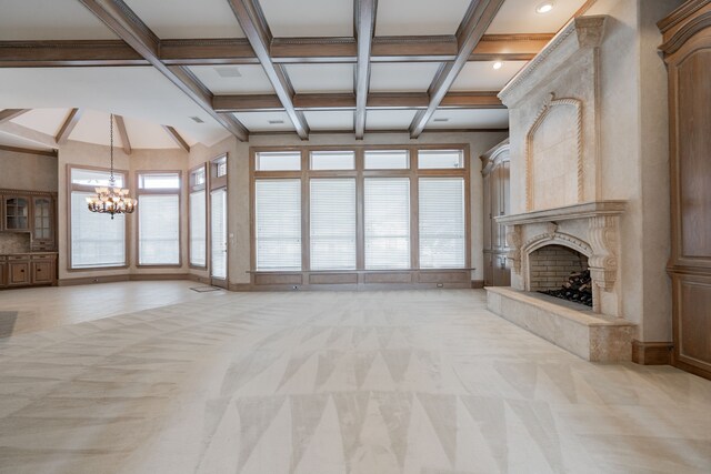 unfurnished living room with beamed ceiling, light colored carpet, coffered ceiling, and an inviting chandelier