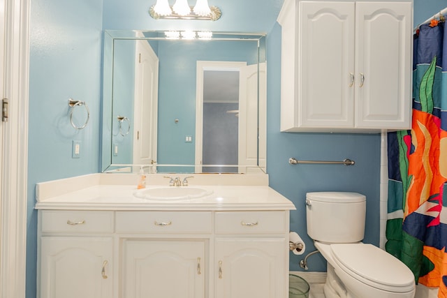 bathroom with walk in shower, vanity, and toilet