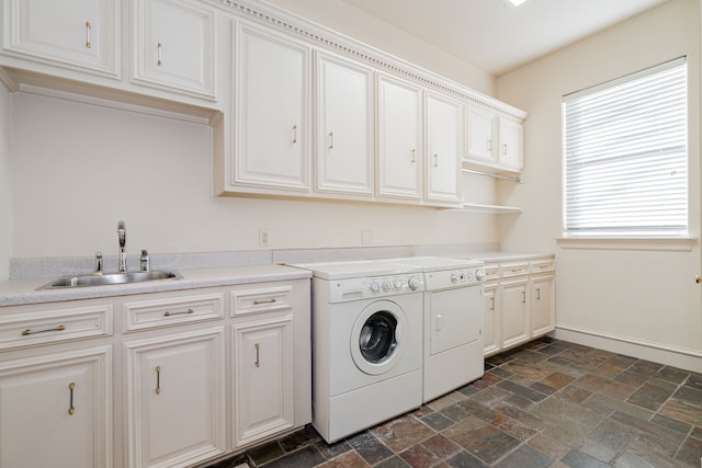 laundry room with cabinets, sink, and washing machine and clothes dryer