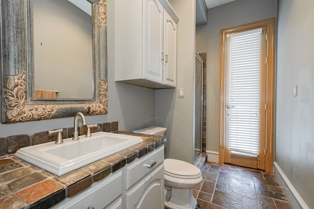 bathroom with plenty of natural light, vanity, and an enclosed shower