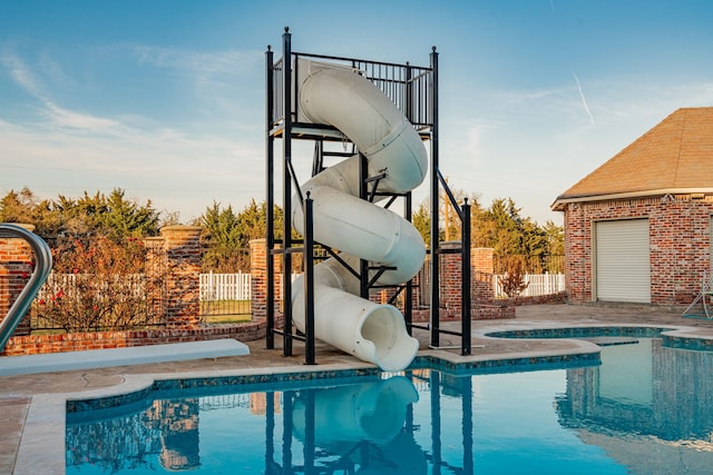 view of swimming pool with a water slide