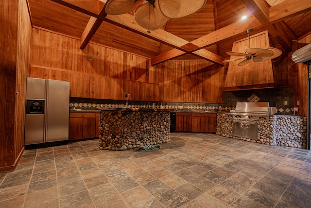 kitchen featuring stainless steel fridge, wooden ceiling, ceiling fan, and wooden walls