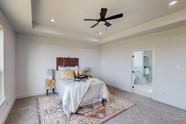 carpeted bedroom featuring ceiling fan and a raised ceiling