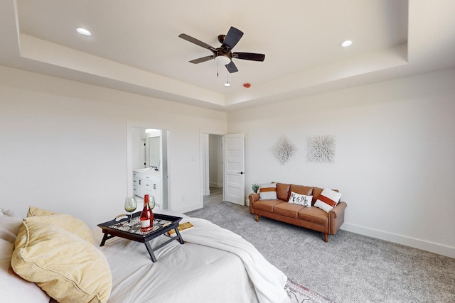 bedroom with carpet floors, a raised ceiling, and ceiling fan