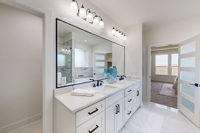 bathroom with vanity and tiled shower