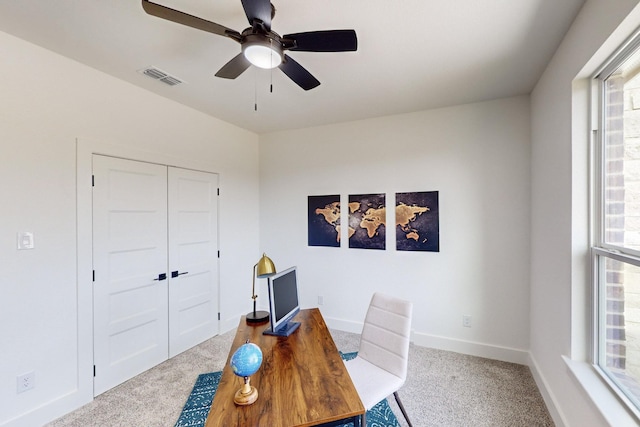 carpeted office with ceiling fan