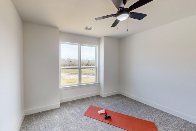 empty room featuring ceiling fan and carpet floors