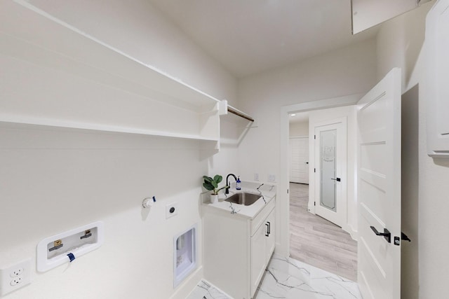 laundry area featuring cabinets, hookup for a washing machine, light wood-type flooring, electric dryer hookup, and sink