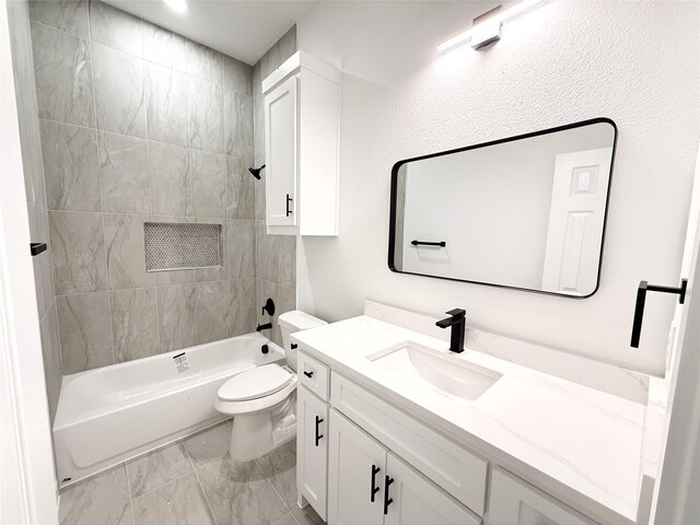 full bathroom with vanity, toilet, and tiled shower / bath