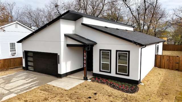 modern home featuring cooling unit and a garage