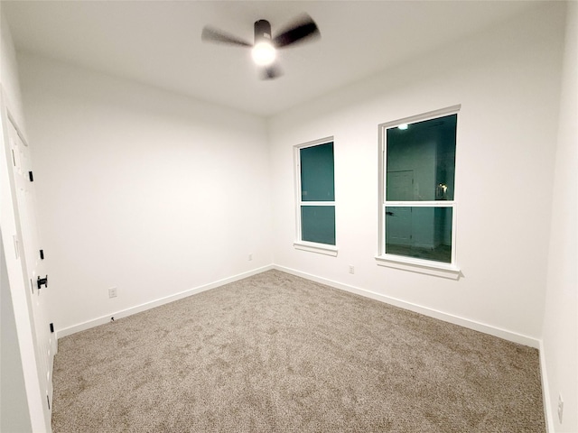 spare room featuring carpet flooring and ceiling fan