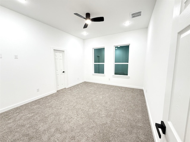 carpeted empty room featuring ceiling fan