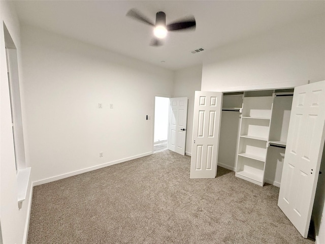 unfurnished bedroom featuring carpet flooring, a closet, and ceiling fan