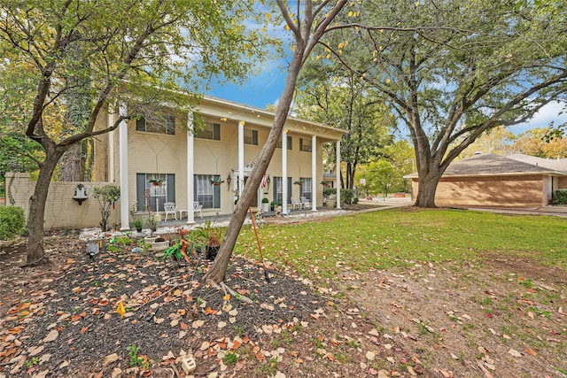 rear view of house featuring a lawn