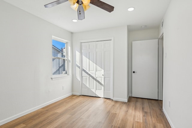 unfurnished bedroom featuring ceiling fan, a closet, and light hardwood / wood-style floors