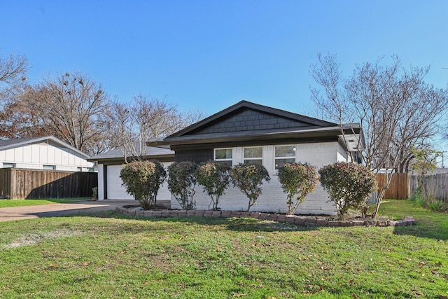 ranch-style home with a garage and a front lawn